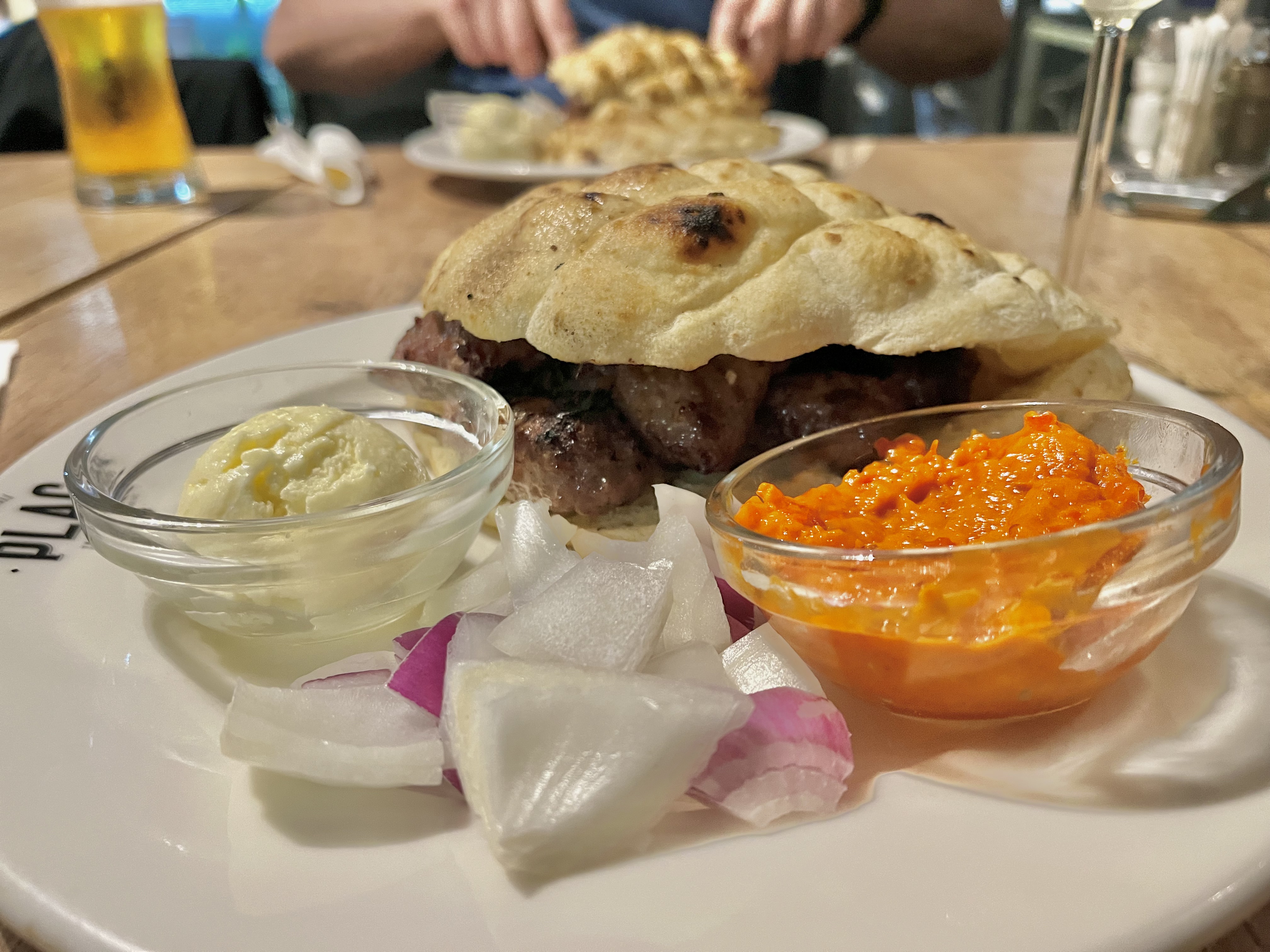 A serving of ćevapi with cream cheese and paprika spread